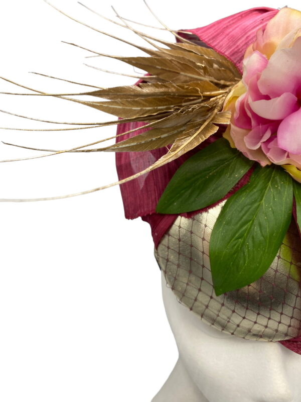 Gold based percher headpiece with stunning burgundy silk abaca detail and finished with pink flowers.